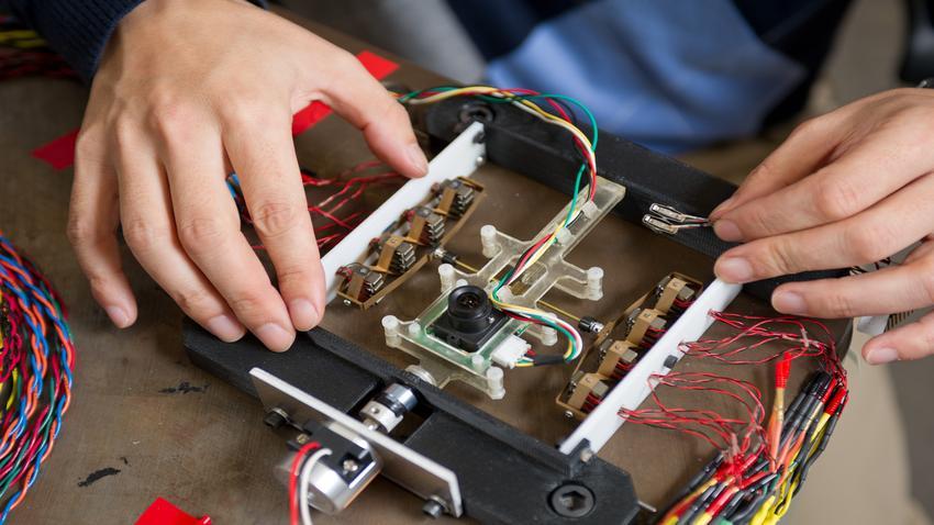 A person's and working on electronics.